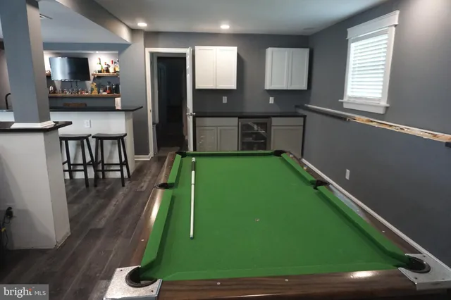 a view of a house with backyard sitting area and swimming pool