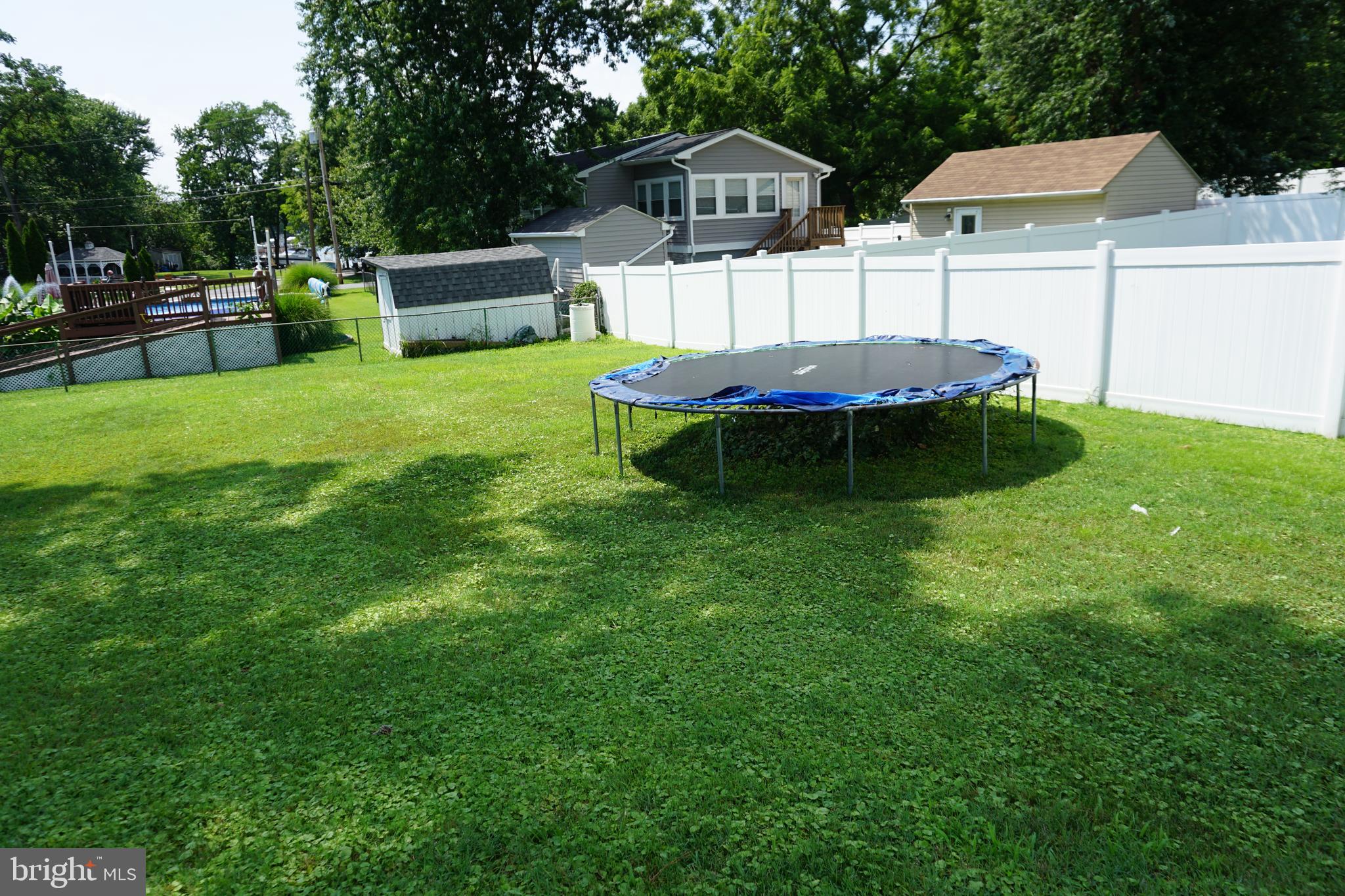 8610 Oak Road Sparrows Point, MD 21219 - Photo 35 of 59 a view of a backyard with table and chairs potted plants and large tree