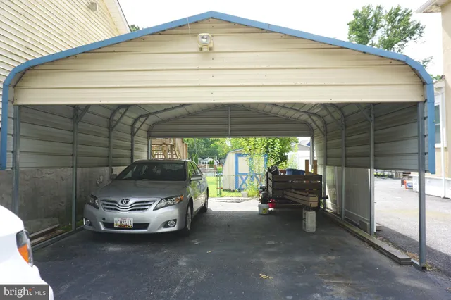 a kitchen with a table chairs refrigerator and sink