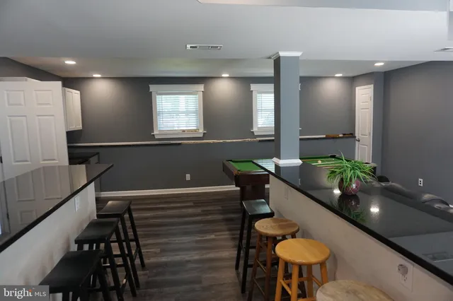 a view of pool table and chairs
