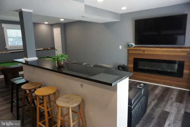 a view of swimming pool with red brick wall and a fire pit