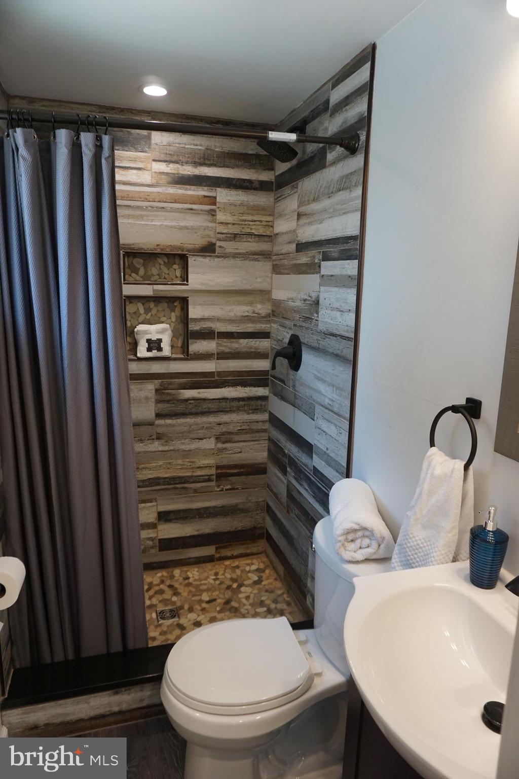 8610 Oak Road Sparrows Point, MD 21219 - Photo 54 of 59 a bathroom with a toilet and a shower