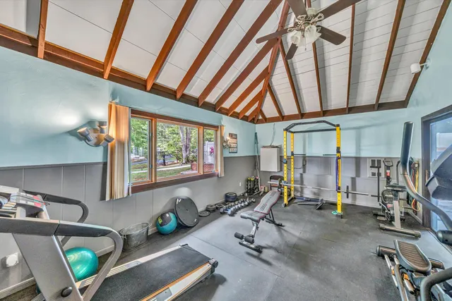 a living room with furniture a window and gym equipment