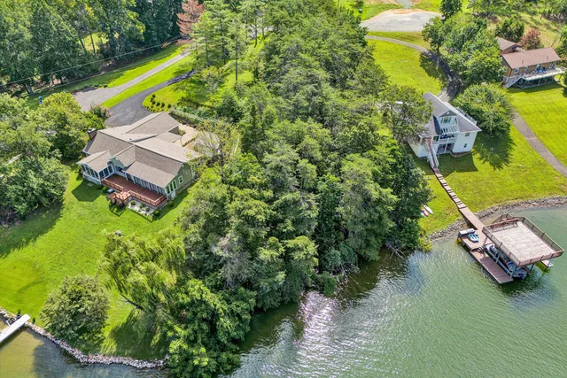 an aerial view of a house with a garden and swimming pool