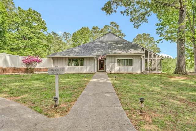 a front view of a house with a garden