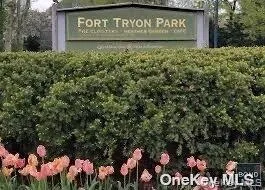 a sign that is sitting in front of flowers