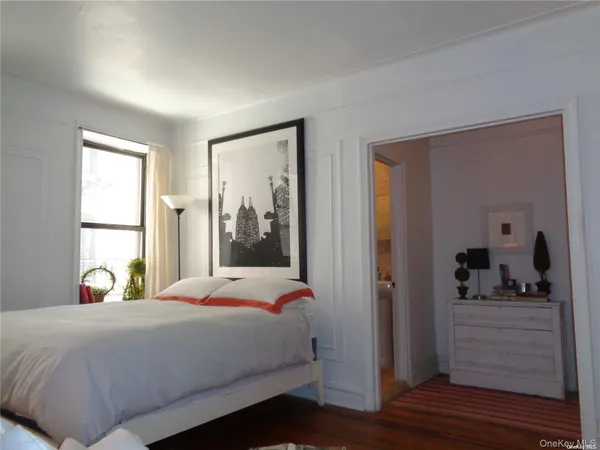 a bedroom with a bed a window and walk in closet