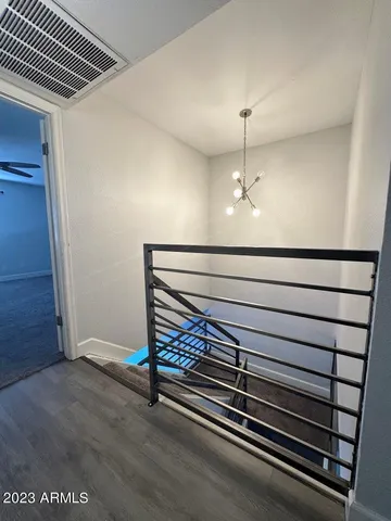 an empty room with a window and a kitchen view