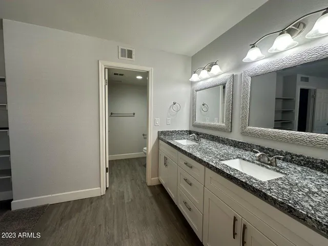 a view of a room with wooden floor and white walls