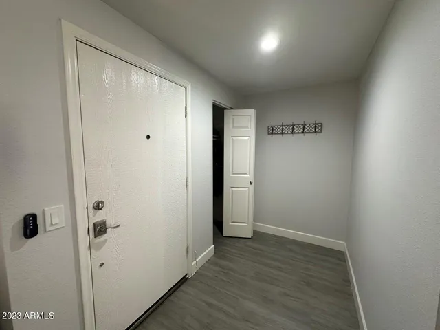 a view of a hallway with wooden floor