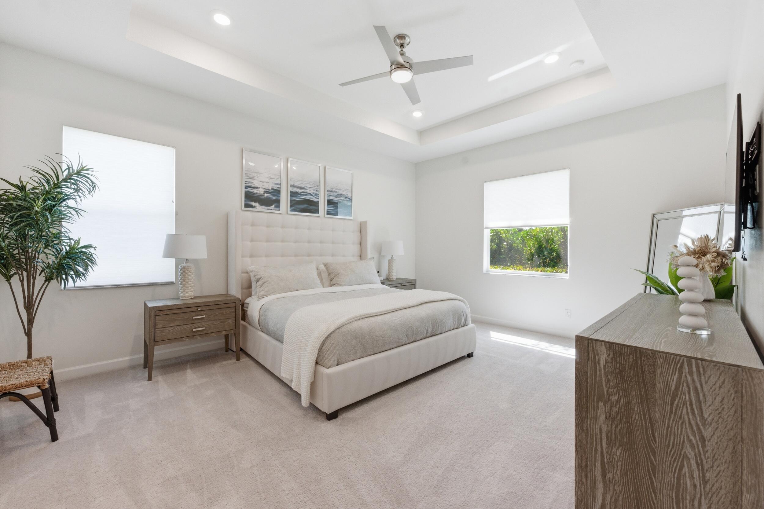 19230 Rolling Acres Road Loxahatchee, FL 33470 - Photo 5 of 58 a bedroom with a bed and a potted plant