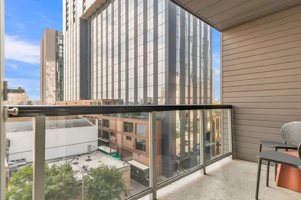 a view of a chairs and table in the balcony