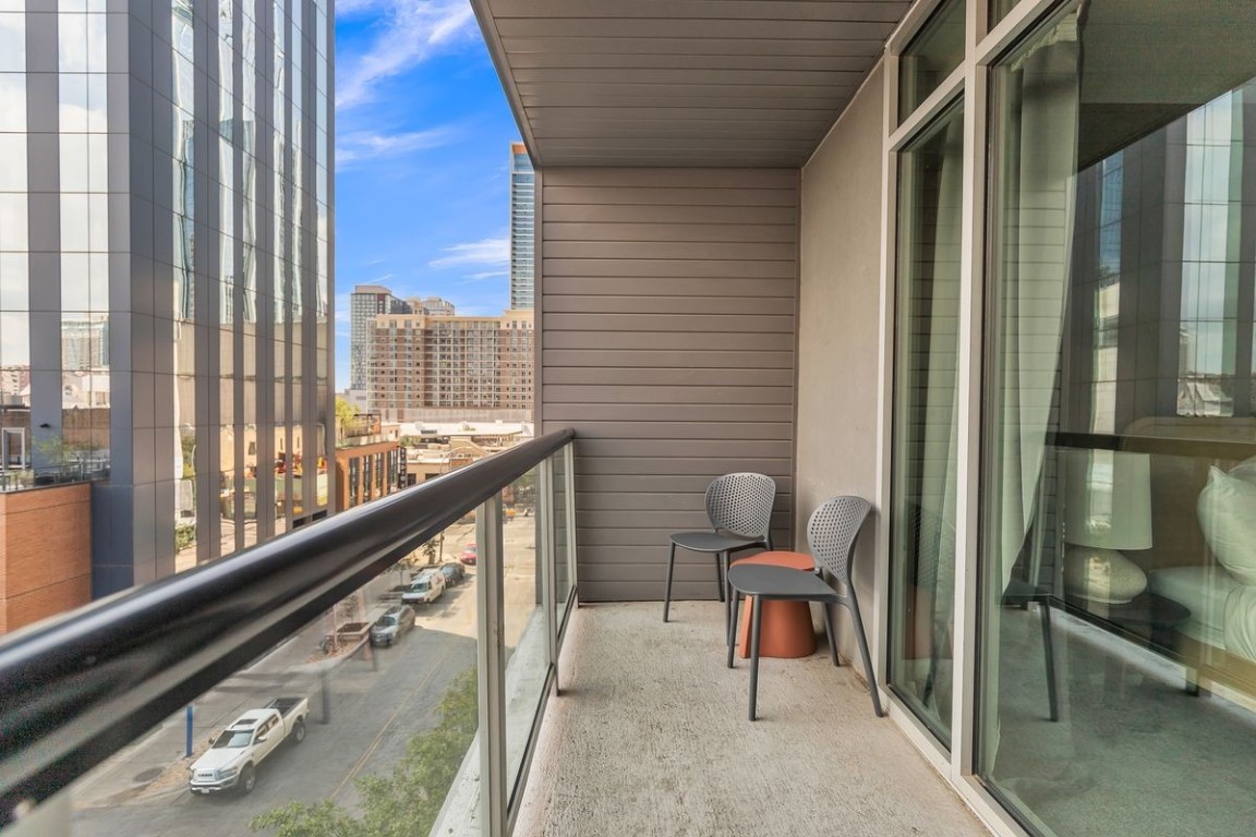119 East 6th Street, Unit 705 Austin, TX 78701 - Photo 19 of 20 a view of a balcony with chairs and a potted plant on a table
