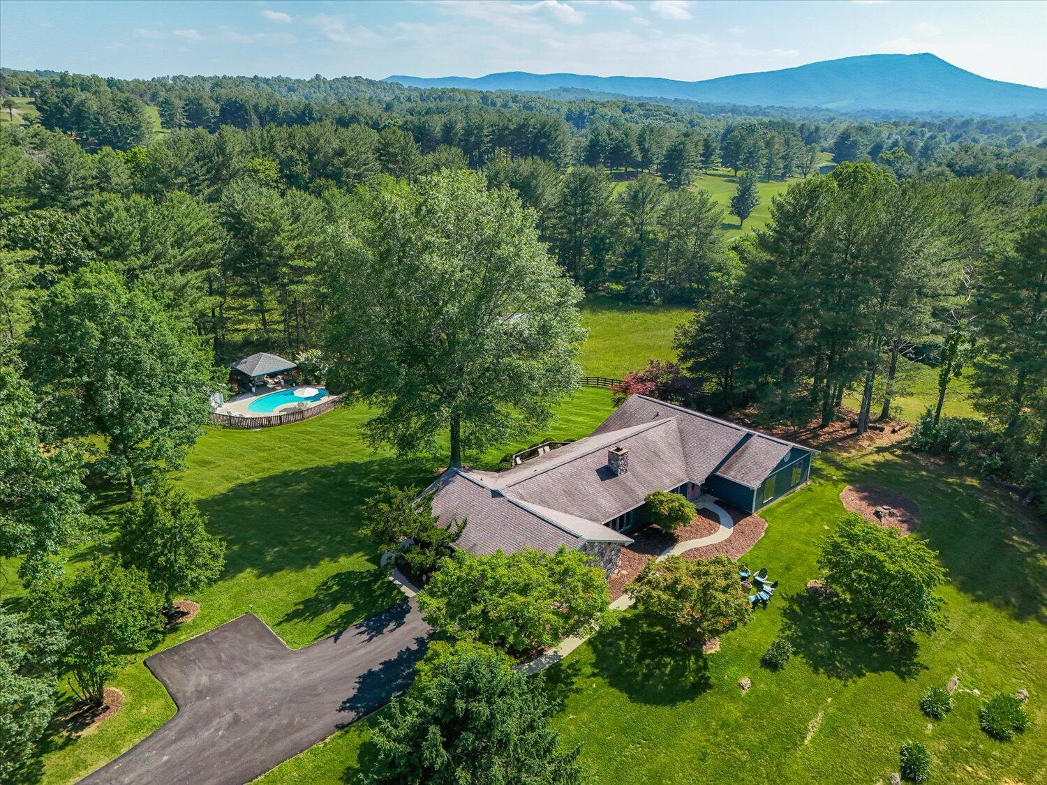 an aerial view of a house with yard