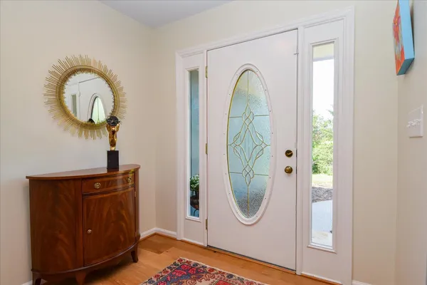 a living room with furniture a flat screen tv and a floor to ceiling window