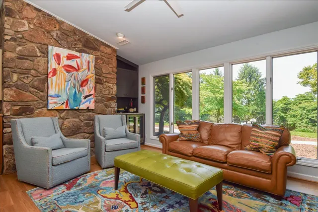a view of a dining room with furniture a rug and wooden floor