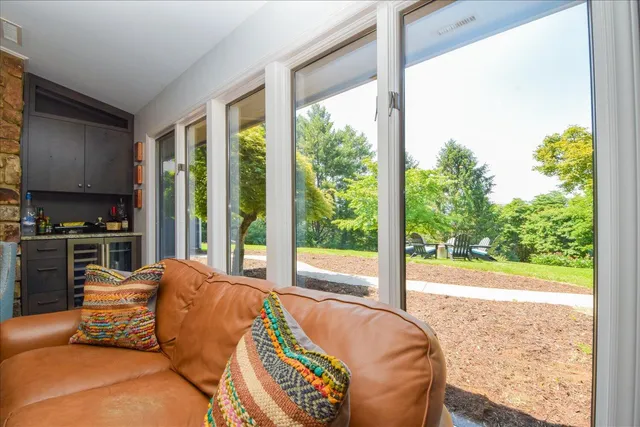 a bedroom with a bed a dresser and painting on the wall