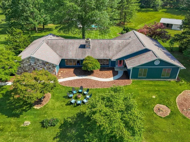 an aerial view of a house with swimming pool garden and patio