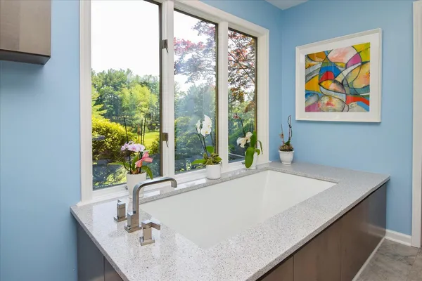 a bathroom with a toilet a sink and a mirror