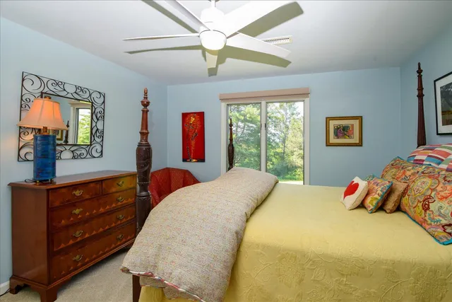 a view of a swimming pool with lawn chairs under an umbrella