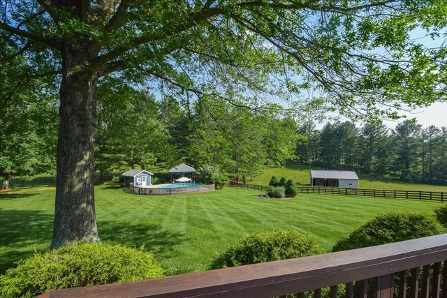 an aerial view of a house with yard swimming pool and outdoor seating