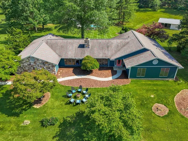 an aerial view of a house with yard