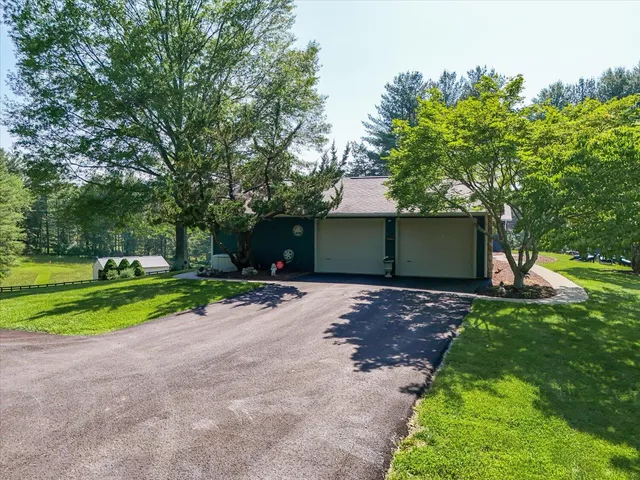 a view of a deck with two chairs and wooden floor