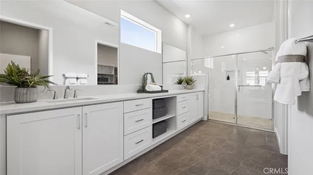 a spacious bathroom with double sink and shower