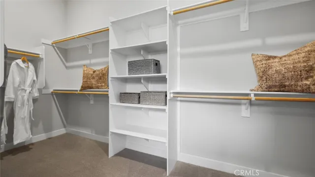 a view of walk in closet with empty racks