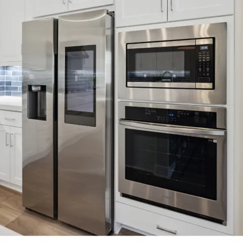 a kitchen with stainless steel appliances and cabinets