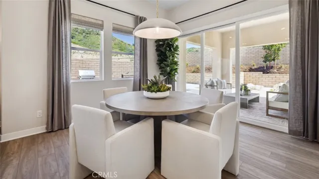 a dining room with furniture window and wooden floor