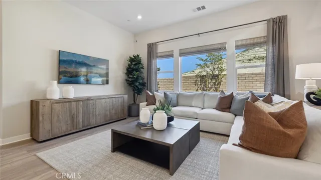a living room with furniture and a large window