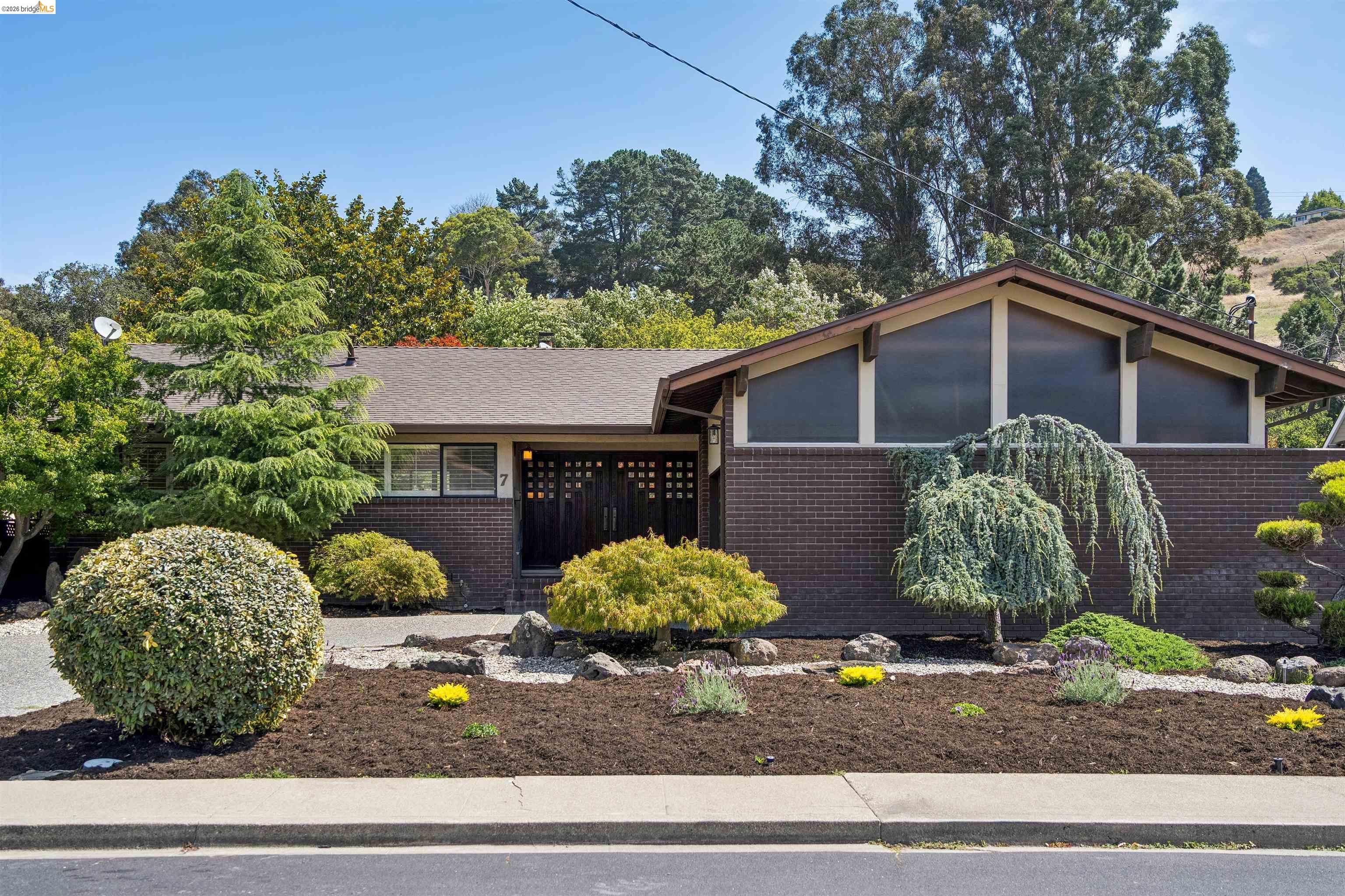 7 Jo Lin Court El Sobrante, CA 94803 - Photo 16 of 99 Mid-century modern exterior featuring a brown brick facade and an A-frame roofline with prominent triangular windows