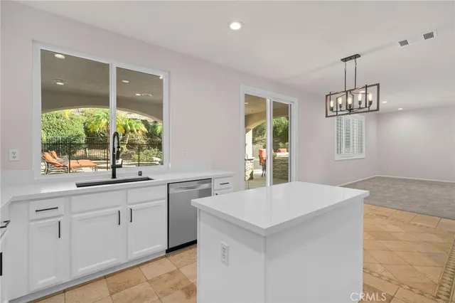 a view of empty room with a kitchen and fireplace
