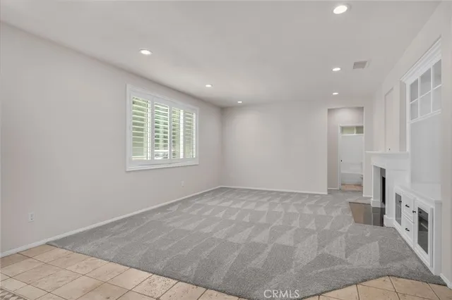 a bathroom with a granite countertop toilet sink and mirror