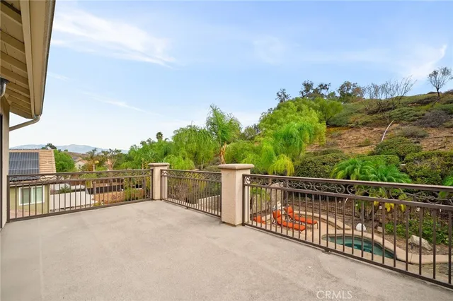 a view of a deck with two chair and a floor to ceiling window