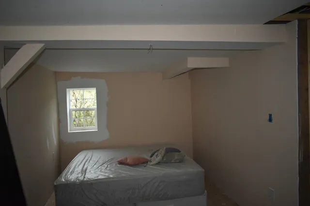 a bedroom with a bed and window