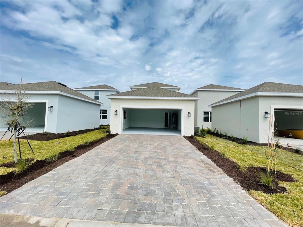 11732 Language Way Orlando, FL 32832 - Photo 24 of 24 a front view of a house with a yard and garage