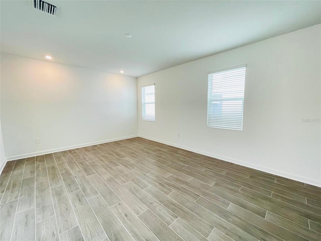 11732 Language Way Orlando, FL 32832 - Photo 9 of 24 a view of empty room with wooden floor and fan