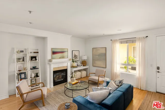 a living room with furniture fireplace and a window