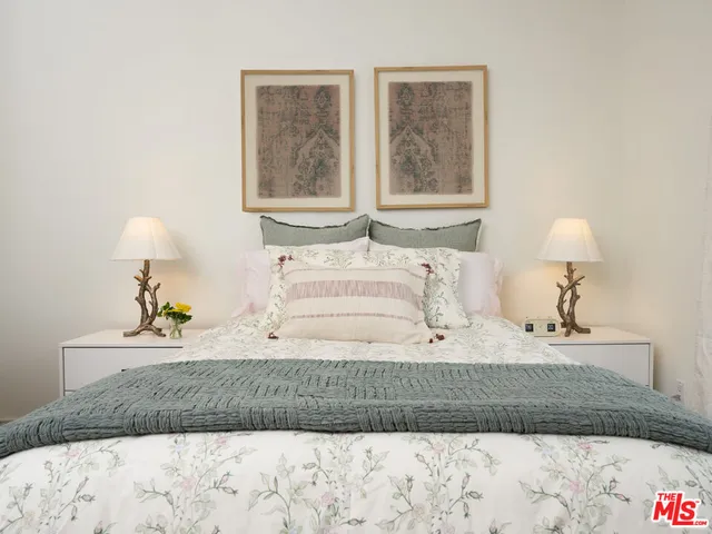 a bedroom with a bed and a lamp on table