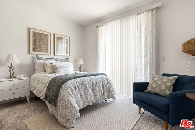 a spacious bedroom with a bed and a couch