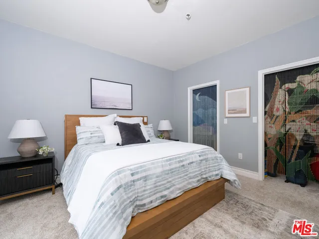 a bedroom with bed and night stand