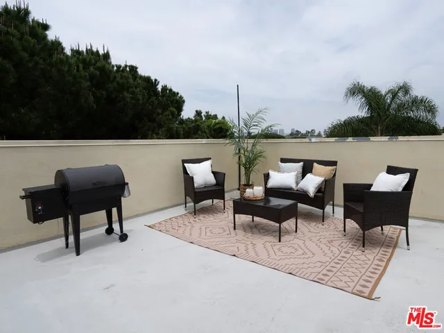 a patio with furniture and a lake view