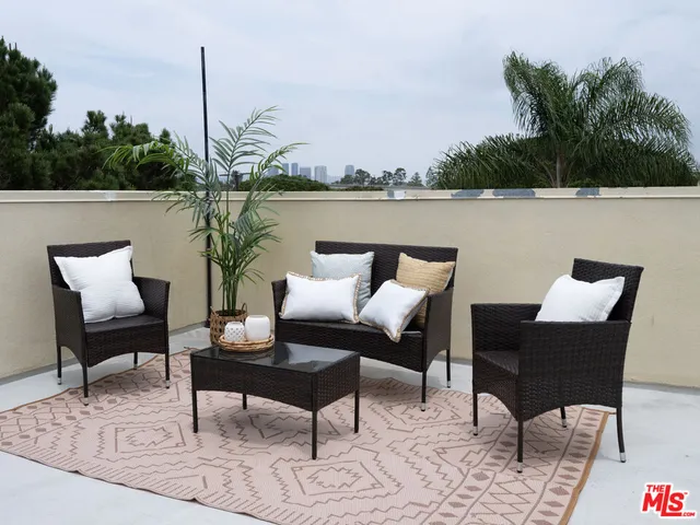 a terrace with outdoor seating and water view