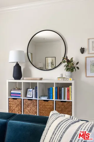 a living room with a bed and a mirror