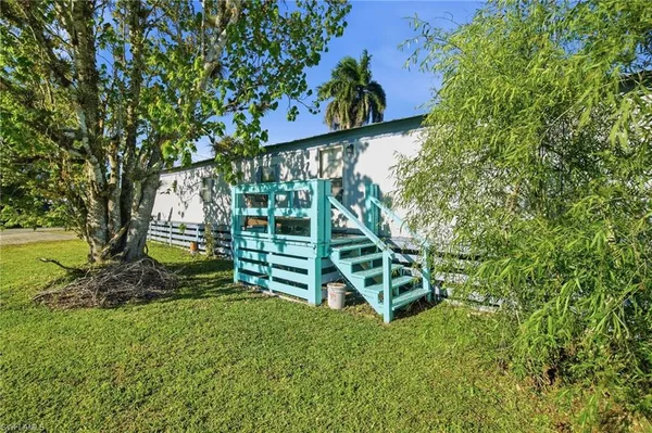 a swimming pool with outdoor seating and yard