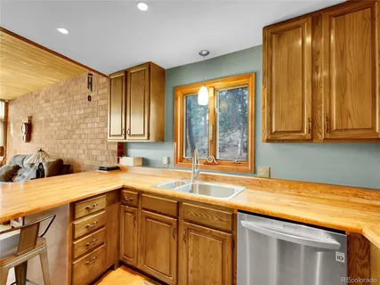 a kitchen with a sink and a window