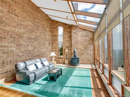 a balcony with furniture and a rug