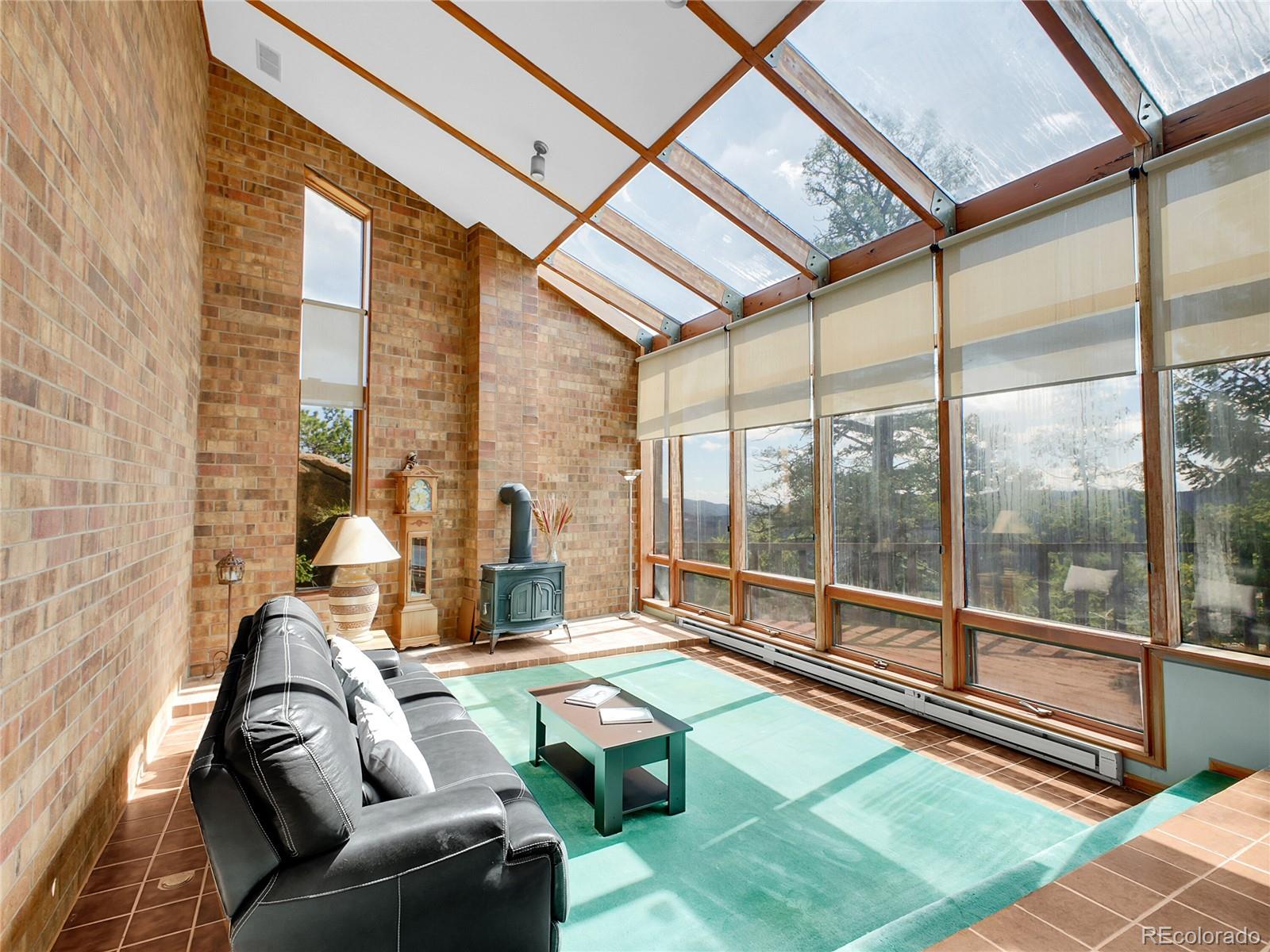 29752 Bearcat Trail Conifer, CO 80433 - Photo 19 of 50 a living room with a couch